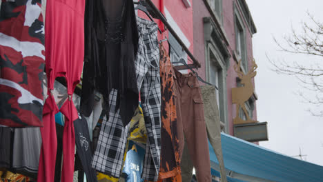 Close-Up-Of-Clothes-Hanging-Outside-Shops-On-Camden-High-Street-In-North-London-UK-1
